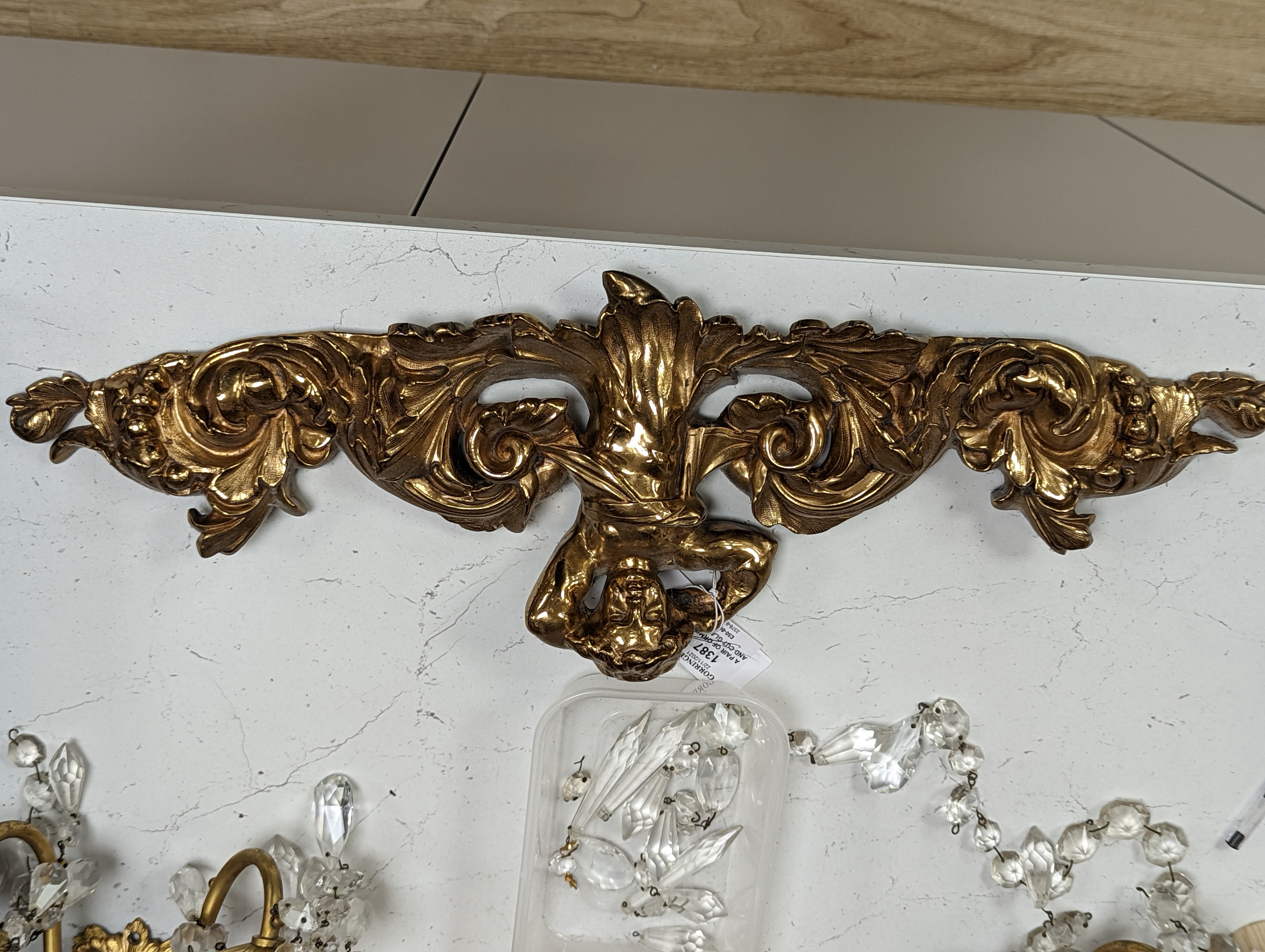 A pair of ormolu and cut glass twin branch wall lights, a bag light and a brass mount